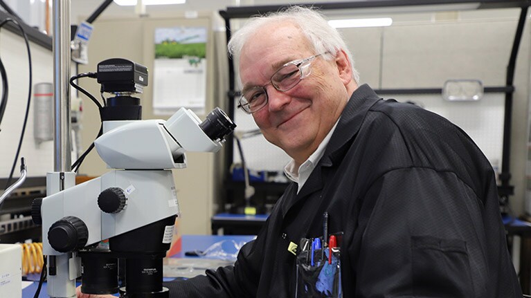 Dr. William F. Cooper junto a un microscopio