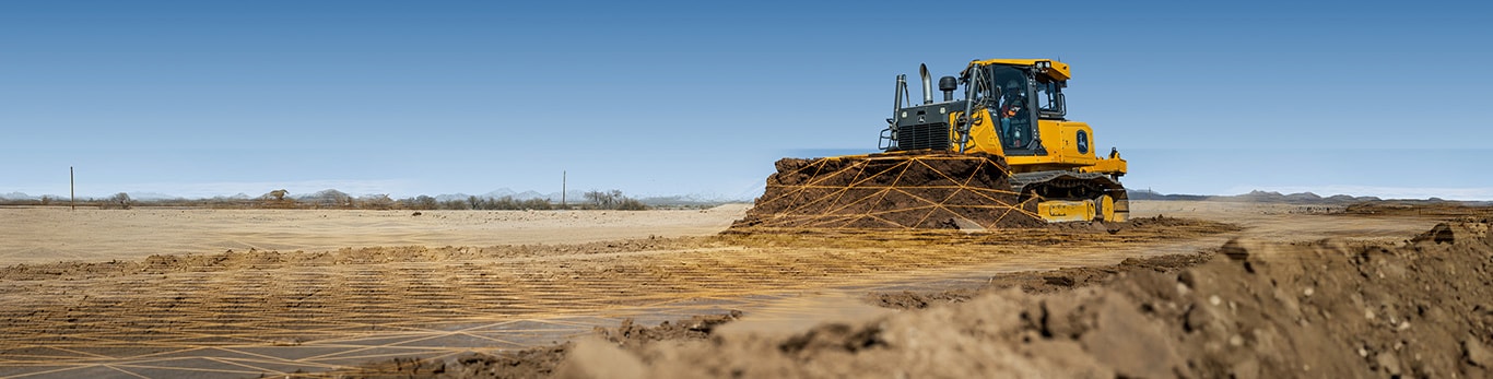 Vehículo de construcción John Deere nivelando la tierra